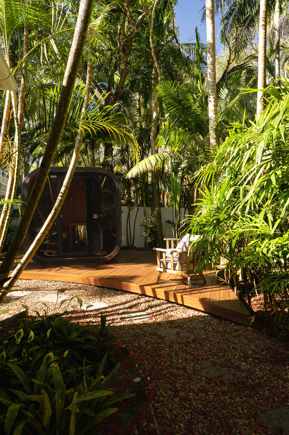 Curved hardwood deck and sauna cabin under the palms