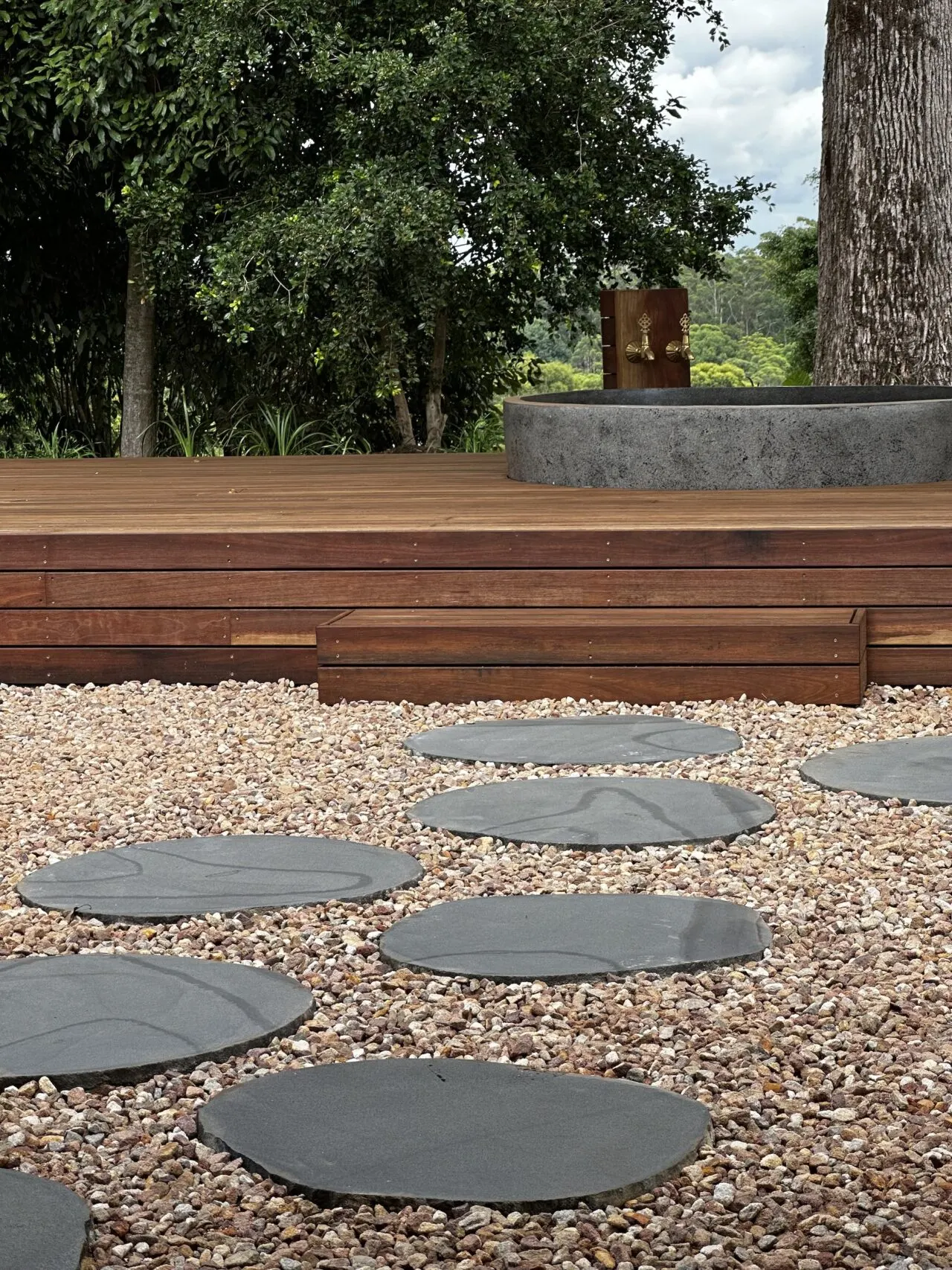 Bluestone stepper path through pebbles to the floating deck