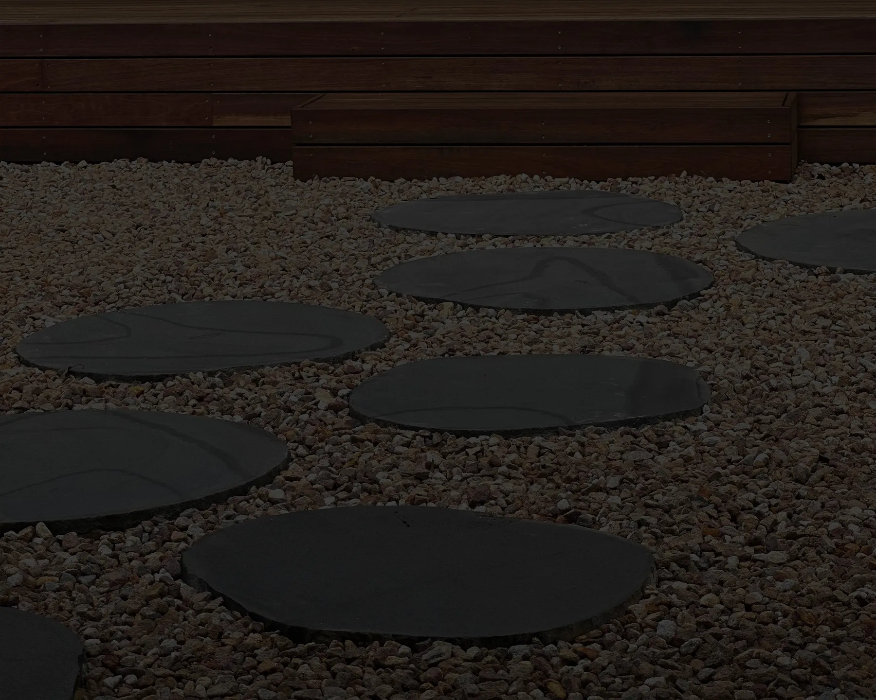 Round bluestone steppers set in white pebbles