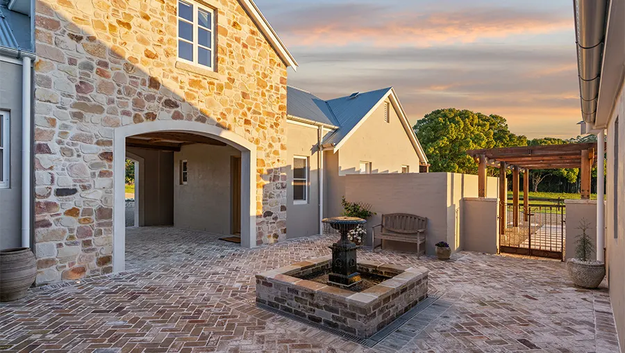 Stone courtyard with central fountain at dusk